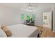 Bright main bedroom with chair and large windows next to adjoining bath with soaking tub at 4900 American Dr, Durham, NC 27705