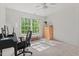 Bright bedroom used as office with large windows, ceiling fan, and natural light at 4900 American Dr, Durham, NC 27705