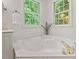 Bright primary bath with corner soaking tub and natural light at 4900 American Dr, Durham, NC 27705