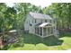 Back exterior with screened-in porch and spacious backyard at 5 Burgess Ct, Hillsborough, NC 27278