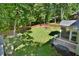 Expansive backyard featuring a screened-in porch, fire pit, and lush greenery at 5 Burgess Ct, Hillsborough, NC 27278