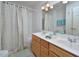 Bathroom featuring a double sink vanity, tile floor, and a shower with a patterned curtain at 5 Burgess Ct, Hillsborough, NC 27278