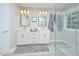 Bathroom featuring a double vanity with modern fixtures, and a walk-in shower with glass enclosure at 5 Burgess Ct, Hillsborough, NC 27278