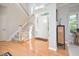 Bright foyer featuring hardwood floors, staircase, and high ceilings at 5 Burgess Ct, Hillsborough, NC 27278