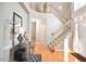 Inviting foyer with hardwood floors, staircase, and elegant decor at 5 Burgess Ct, Hillsborough, NC 27278