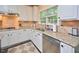 Well-lit kitchen with stainless steel appliances, granite countertops, and ample cabinet space at 5 Burgess Ct, Hillsborough, NC 27278