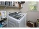 Well-equipped laundry room with modern washer and dryer, convenient shelving for storage, and natural light from a window at 5 Burgess Ct, Hillsborough, NC 27278