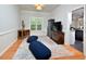 Relaxing sitting room boasts wood floors, natural light, and a view into the kitchen at 5 Burgess Ct, Hillsborough, NC 27278