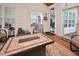 Enclosed sunroom with a cozy seating area and bright natural light at 5 Burgess Ct, Hillsborough, NC 27278