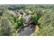Aerial view of townhomes surrounded by lush green trees and overlooking a pond, offering serene natural beauty at 51 Abernathy Dr, Chapel Hill, NC 27517