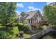 Exterior view of the home featuring a deck and lush landscaping with water feature at 51 Abernathy Dr, Chapel Hill, NC 27517
