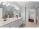 Bathroom featuring double sinks, a glass shower, and a doorway leading to a walk-in closet at 51 Abernathy Dr, Chapel Hill, NC 27517