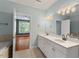 Bathroom featuring double sinks, tile floors, and a view into an adjacent bedroom at 51 Abernathy Dr, Chapel Hill, NC 27517