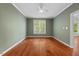 Bright bedroom with hardwood floors, white trim, and a large window offering natural light at 51 Abernathy Dr, Chapel Hill, NC 27517