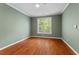 Empty bedroom with hardwood floors and a single window at 51 Abernathy Dr, Chapel Hill, NC 27517