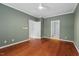 Bedroom with hardwood floors, white trim, and multiple doorways leading to other rooms at 51 Abernathy Dr, Chapel Hill, NC 27517
