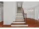 Bright foyer with hardwood floors, staircase, and elegant chandelier, creating a warm welcome at 51 Abernathy Dr, Chapel Hill, NC 27517