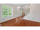Elegant foyer with hardwood floors, stairs, and natural light, perfect for welcoming guests at 51 Abernathy Dr, Chapel Hill, NC 27517