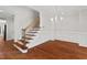 Spacious foyer with wooden stairs, hardwood floors, and elegant chandelier, perfect for entertaining at 51 Abernathy Dr, Chapel Hill, NC 27517