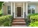 Elegant front door with sidelights and black iron railing, set in a brick entryway at 51 Abernathy Dr, Chapel Hill, NC 27517