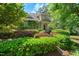 Charming home with mature landscaping, including colorful shrubbery and lush greenery at 51 Abernathy Dr, Chapel Hill, NC 27517