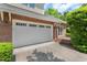 Spacious two-car garage with white doors and brick exterior, offering convenient parking at 51 Abernathy Dr, Chapel Hill, NC 27517