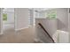 Hallway featuring a staircase with a wooden railing and white built-in bookshelves at 51 Abernathy Dr, Chapel Hill, NC 27517