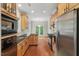 Well-equipped kitchen with wooden cabinets, stainless steel appliances, and hardwood floors at 51 Abernathy Dr, Chapel Hill, NC 27517