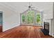 Bright living room with hardwood flooring, a fireplace, and large windows providing natural light and views at 51 Abernathy Dr, Chapel Hill, NC 27517