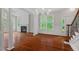 Open-concept living room with hardwood floors, fireplace, and large windows offering natural light at 51 Abernathy Dr, Chapel Hill, NC 27517