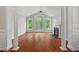 Bright living room featuring fireplace, hardwood floors, and access to balcony, offering a relaxing retreat at 51 Abernathy Dr, Chapel Hill, NC 27517
