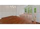 Sunlit living room with hardwood floors, wainscoting, and French doors leading to the backyard at 51 Abernathy Dr, Chapel Hill, NC 27517
