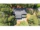 Aerial view of the home's roof and driveway, showcasing its layout and mature tree surroundings at 512 Stratford Dr, Zebulon, NC 27597