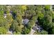 Aerial view of the property, showcasing lush trees and multiple structures at 512 Stratford Dr, Zebulon, NC 27597
