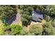 Aerial view showcasing the home, tennis court, and surrounding greenery at 512 Stratford Dr, Zebulon, NC 27597