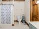 Cozy bathroom featuring a shower with an Eiffel Tower curtain, a toilet, and storage at 512 Stratford Dr, Zebulon, NC 27597