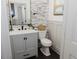 Updated half bath with modern fixtures and stylish tile accent wall at 512 Stratford Dr, Zebulon, NC 27597