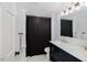 Stylish bathroom featuring double sinks, modern fixtures, and a shower with a black curtain at 512 Stratford Dr, Zebulon, NC 27597