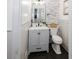 Updated half bath with modern fixtures and stylish tile accent wall at 512 Stratford Dr, Zebulon, NC 27597