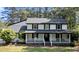 Charming two-story home with a covered front porch and mature trees at 512 Stratford Dr, Zebulon, NC 27597
