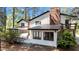 White home with a brick chimney, a deck, a screened porch, and a metal roof at 512 Stratford Dr, Zebulon, NC 27597