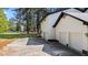 The back exterior features an ample concrete parking pad and a three-car garage at 512 Stratford Dr, Zebulon, NC 27597
