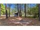 Outdoor fire pit area with brick pavers, ideal for cozy evenings surrounded by mature trees at 512 Stratford Dr, Zebulon, NC 27597