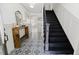 The foyer boasts stylish black and white tile flooring and a staircase at 512 Stratford Dr, Zebulon, NC 27597
