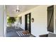 Charming front porch with white railings, black door, and rocking chairs at 512 Stratford Dr, Zebulon, NC 27597