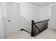 Upstairs hallway with wainscoting, black railing, and access to multiple rooms at 512 Stratford Dr, Zebulon, NC 27597