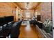 Home office with wooden paneling, brick fireplace, built-in shelving, comfortable seating, and natural light at 512 Stratford Dr, Zebulon, NC 27597