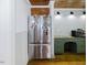 Kitchen features stainless steel fridge, green cabinets, wooden ceiling and modern appliances at 512 Stratford Dr, Zebulon, NC 27597
