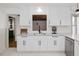 Bright kitchen features white cabinetry, granite countertops, stainless steel appliances, and modern fixtures at 512 Stratford Dr, Zebulon, NC 27597
