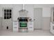 Kitchen with stainless steel oven and hood, as well as a tiled backsplash at 512 Stratford Dr, Zebulon, NC 27597